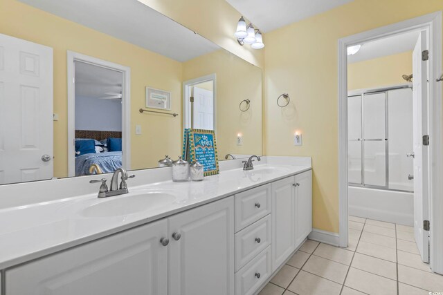 bathroom featuring ceiling fan, tile patterned flooring, vanity, and enclosed tub / shower combo