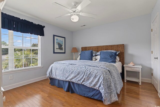 bedroom with ceiling fan and hardwood / wood-style flooring