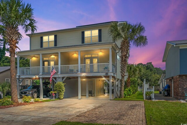 raised beach house with a carport and a porch