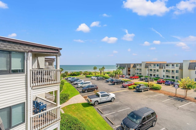 uncovered parking lot with a water view