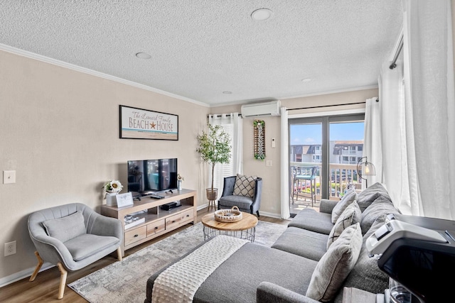 living room featuring a wall unit AC, crown molding, baseboards, and wood finished floors