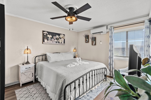 bedroom with crown molding, a wall mounted AC, a ceiling fan, a textured ceiling, and wood finished floors