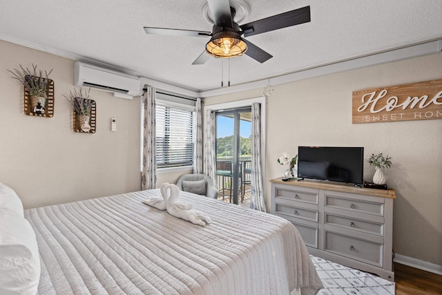 bedroom with a ceiling fan, a wall unit AC, light wood-style flooring, access to exterior, and a textured ceiling