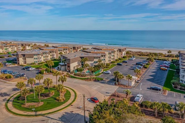 birds eye view of property with a beach view and a water view