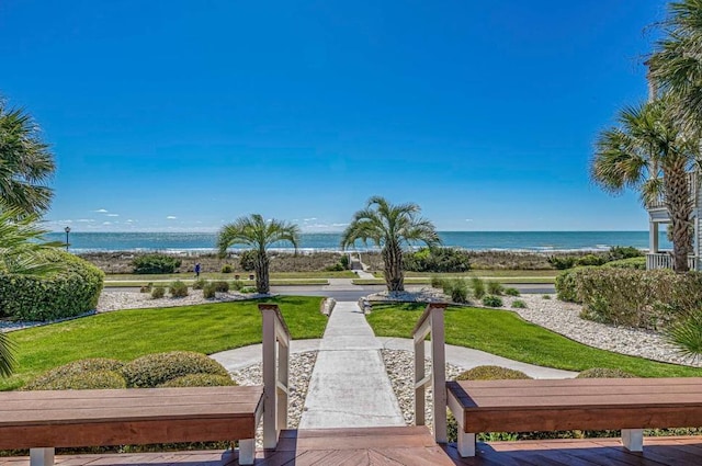 view of community featuring a water view and a lawn