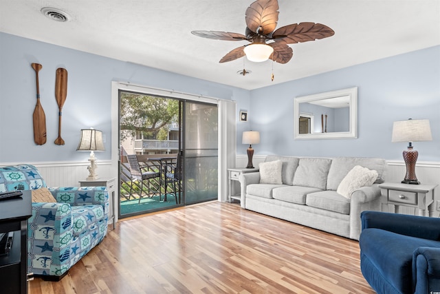 living room featuring ceiling fan and light wood-type flooring