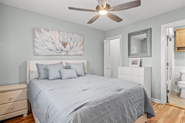 bedroom with ceiling fan, connected bathroom, and light hardwood / wood-style floors