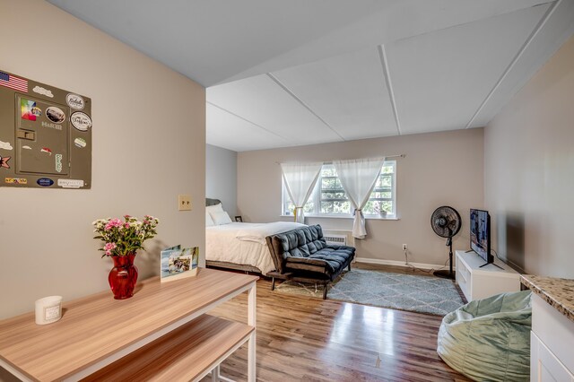 bedroom featuring wood finished floors and baseboards