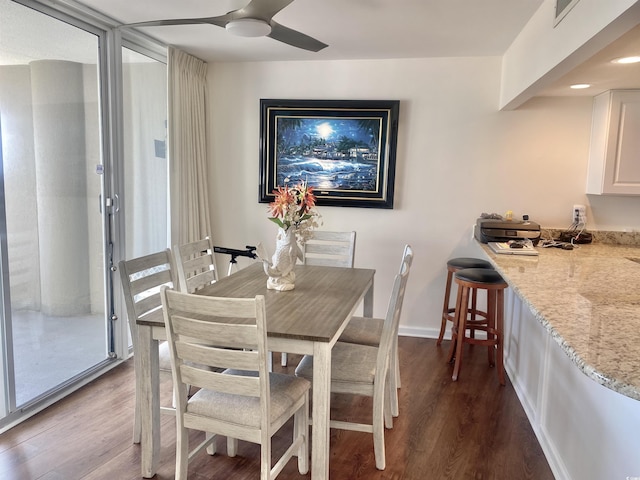 dining area featuring ceiling fan and dark hardwood / wood-style flooring