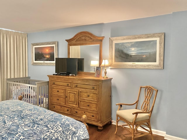 bedroom with dark hardwood / wood-style floors