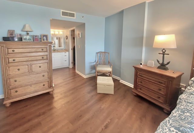 bedroom with a chandelier and dark hardwood / wood-style flooring