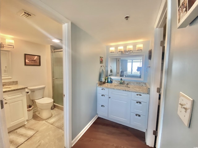 bathroom with vanity, toilet, and wood-type flooring