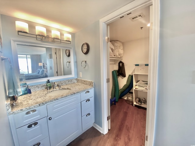 bathroom with vanity and hardwood / wood-style floors