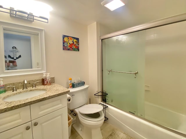 full bathroom featuring vanity, toilet, and combined bath / shower with glass door