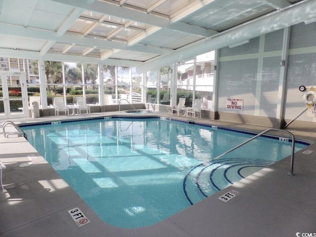 view of swimming pool with glass enclosure