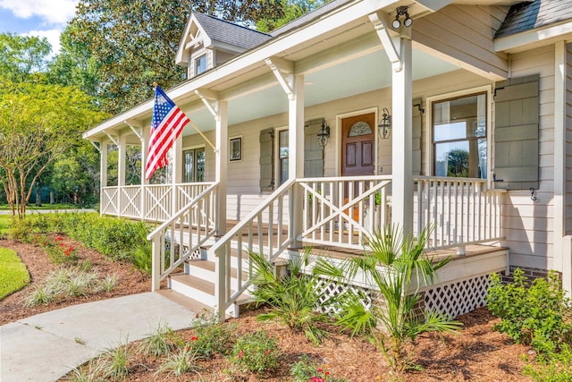 view of exterior entry featuring a porch