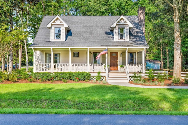 cape cod-style house with a front lawn and a porch