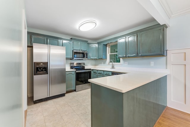 kitchen with appliances with stainless steel finishes, light hardwood / wood-style floors, kitchen peninsula, ornamental molding, and sink