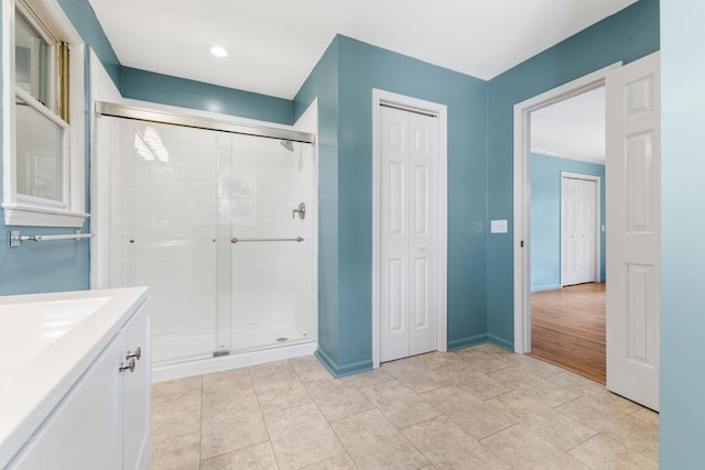 bathroom featuring hardwood / wood-style flooring, vanity, ornamental molding, and an enclosed shower