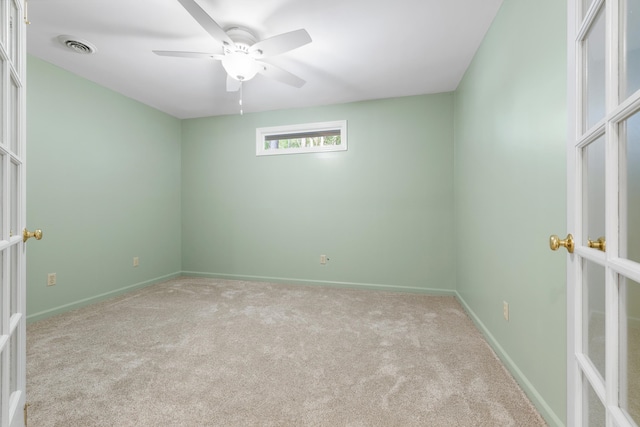 carpeted spare room with ceiling fan