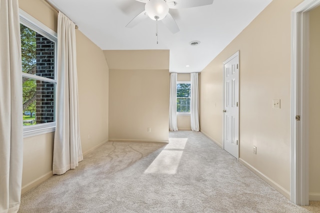 empty room featuring ceiling fan and light carpet