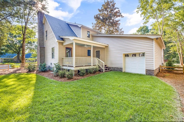 view of front facade featuring a front yard, a garage, and a porch