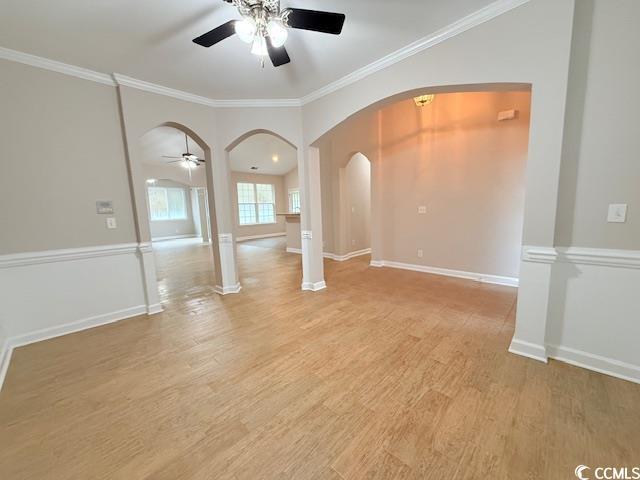 spare room featuring crown molding, ceiling fan, and light hardwood / wood-style flooring