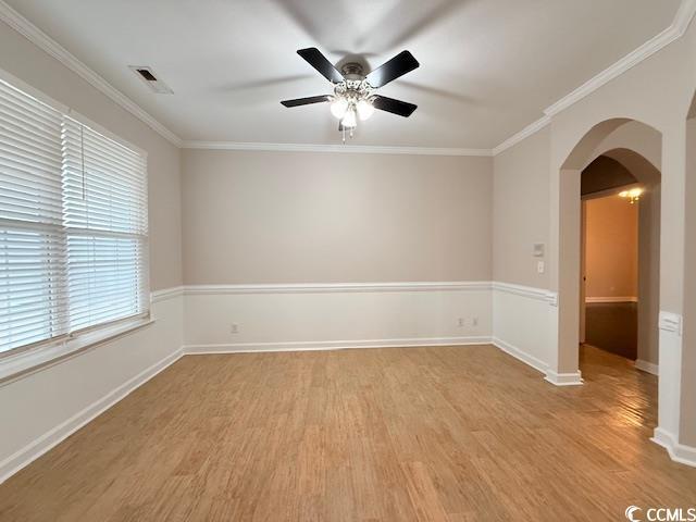 spare room featuring ornamental molding, light hardwood / wood-style floors, and ceiling fan