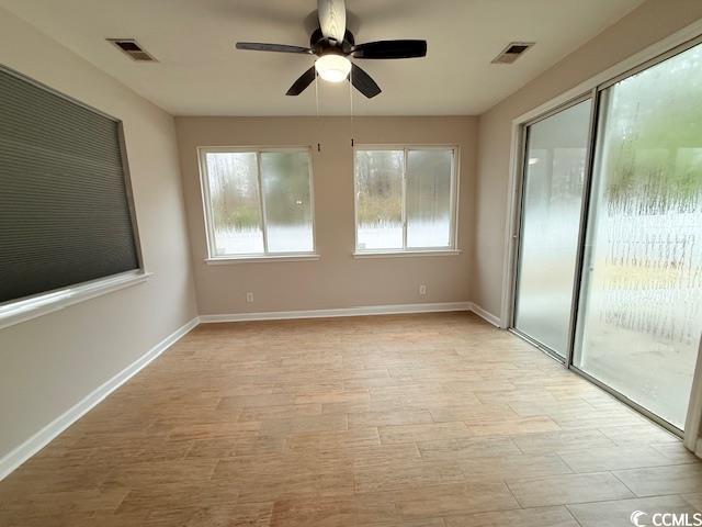 unfurnished room featuring ceiling fan, a healthy amount of sunlight, and light hardwood / wood-style floors