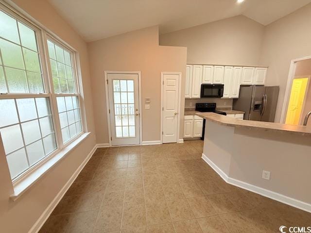 kitchen featuring vaulted ceiling, white cabinets, light tile patterned floors, electric range, and stainless steel refrigerator with ice dispenser