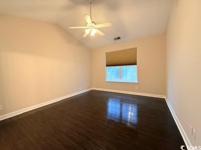 spare room with vaulted ceiling, ceiling fan, and dark hardwood / wood-style flooring