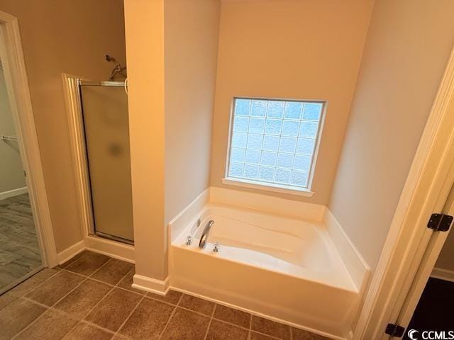 bathroom featuring tile patterned floors and plus walk in shower