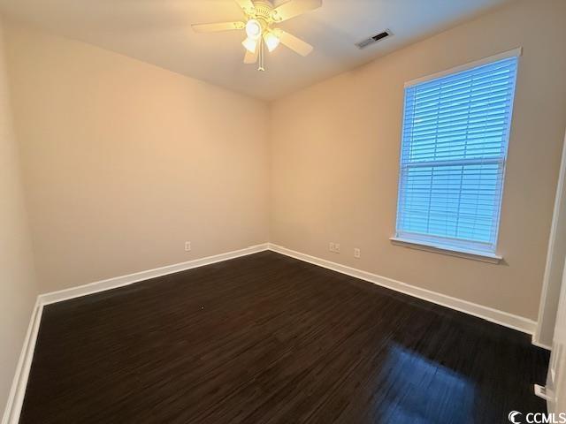 spare room with hardwood / wood-style flooring and ceiling fan