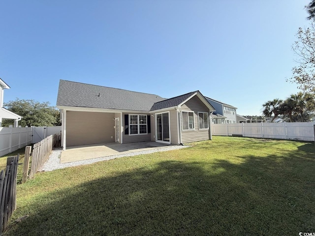 rear view of property featuring a yard and a patio area