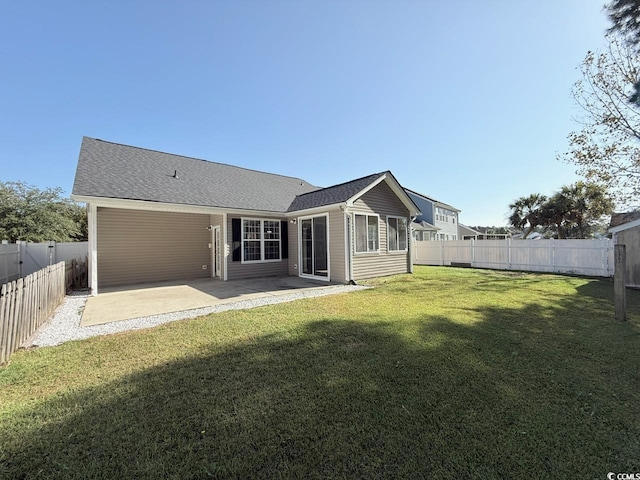 back of house featuring a yard and a patio area