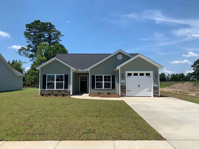 view of front facade featuring a garage and a front lawn