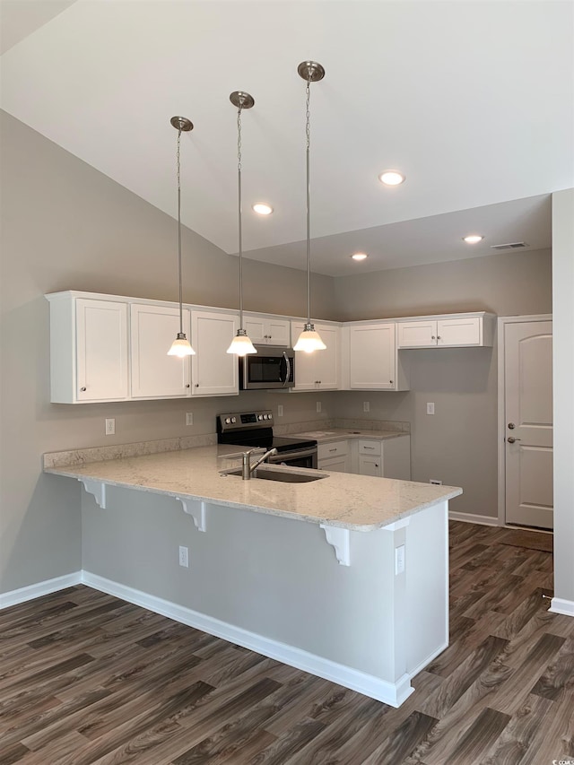 kitchen featuring kitchen peninsula, hanging light fixtures, stainless steel appliances, vaulted ceiling, and white cabinets