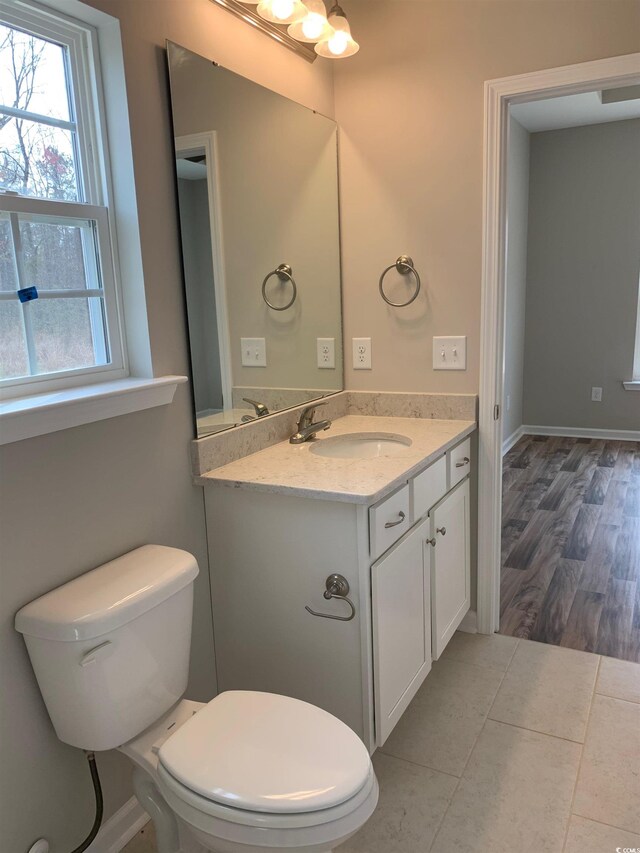 bathroom featuring vanity, hardwood / wood-style flooring, and toilet