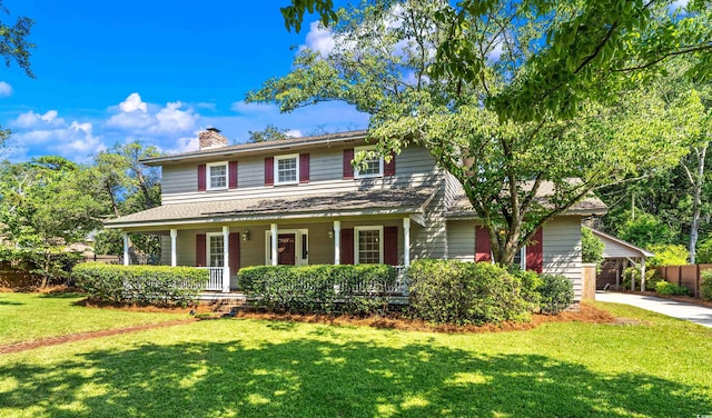 view of front of house with a front yard and covered porch