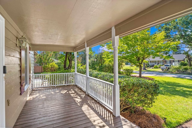 deck with a yard and a porch