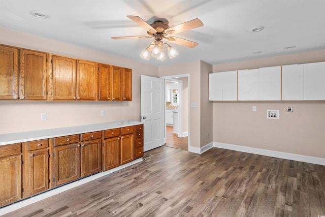 kitchen with ceiling fan and hardwood / wood-style flooring