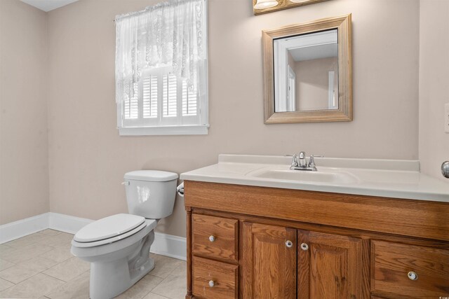 bathroom featuring vanity, toilet, and tile patterned flooring