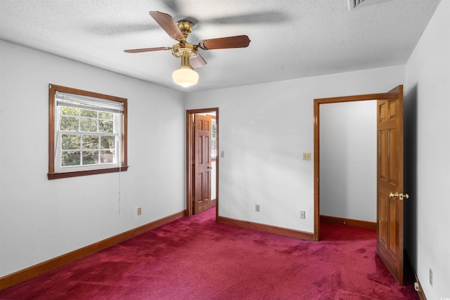 unfurnished room with ceiling fan, carpet, and a textured ceiling