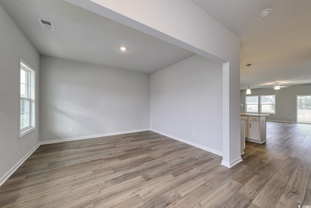 empty room featuring ceiling fan and light wood-type flooring