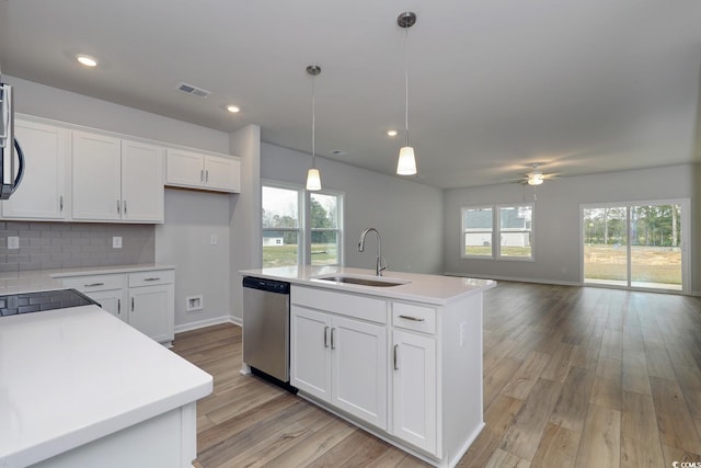 kitchen with a healthy amount of sunlight, sink, an island with sink, and stainless steel appliances