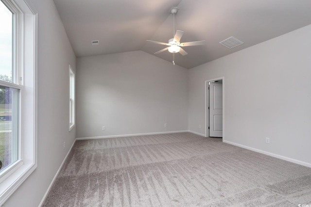 carpeted spare room with vaulted ceiling and ceiling fan