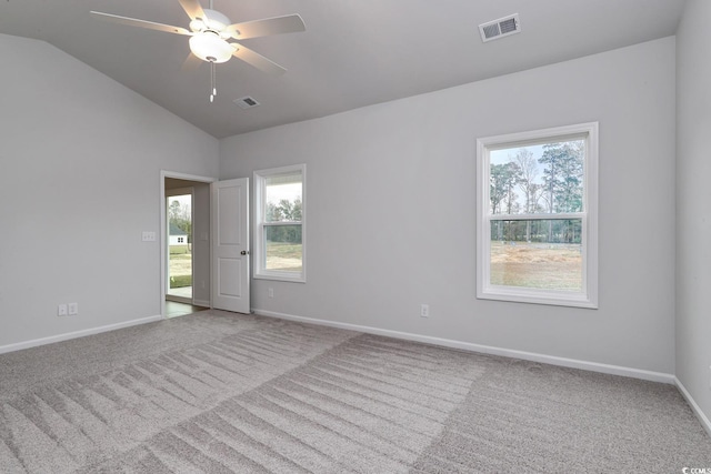 unfurnished room featuring plenty of natural light, lofted ceiling, and ceiling fan