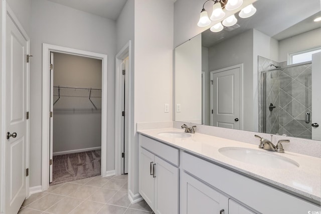 bathroom with tile patterned floors, vanity, and a shower with door