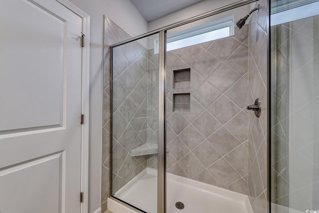 bathroom featuring a shower with door