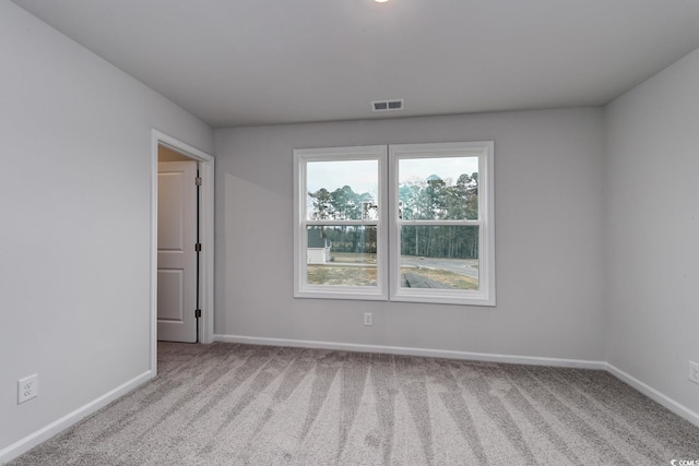 spare room with light colored carpet